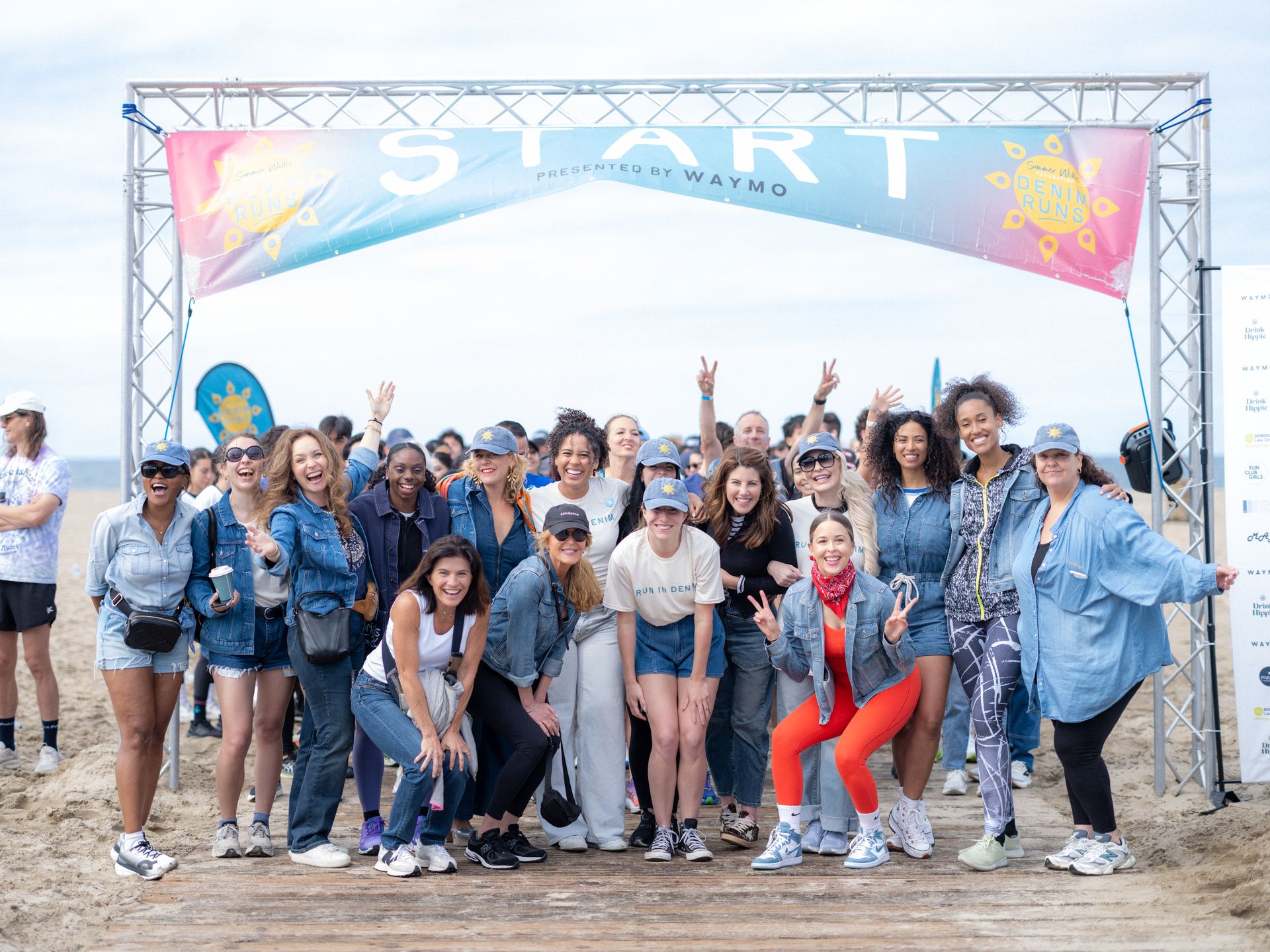Participants in denim gathered under the start arch at The Denim Run Los Angeles